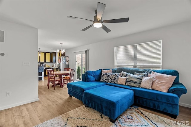 757 Fox Creek Dr, Fenton, MO 63026 - living area with ceiling fan, light wood-style flooring, baseboards, and a chandelier