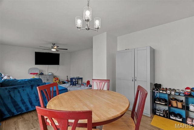 757 Fox Creek Dr, Fenton, MO 63026 - dining area featuring light wood-style flooring, ceiling fan, and a chandelier