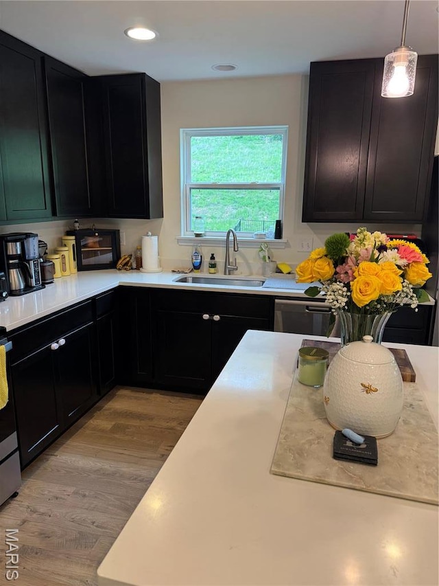 757 Fox Creek Dr, Fenton, MO 63026 - kitchen featuring dark cabinets, light countertops, light wood-style flooring, dishwasher, and recessed lighting