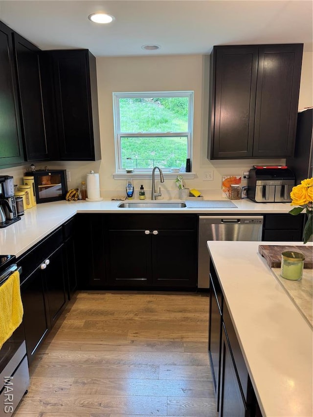 757 Fox Creek Dr, Fenton, MO 63026 - kitchen with light wood finished floors, dark cabinets, appliances with stainless steel finishes, light countertops, and recessed lighting