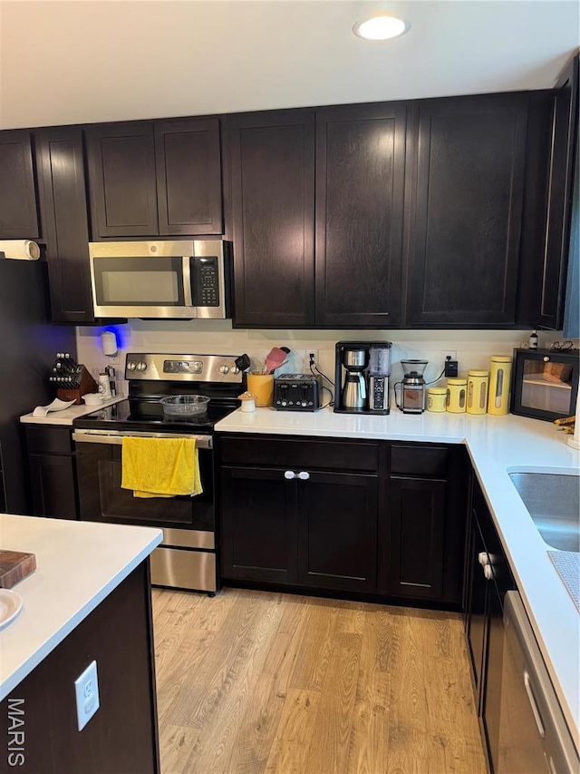 757 Fox Creek Dr, Fenton, MO 63026 - kitchen featuring appliances with stainless steel finishes, light countertops, and light wood-type flooring