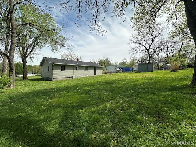 501 N Warfel St, Salem, MO 65560 - view of grassy yard featuring a storage shed and an outdoor structure