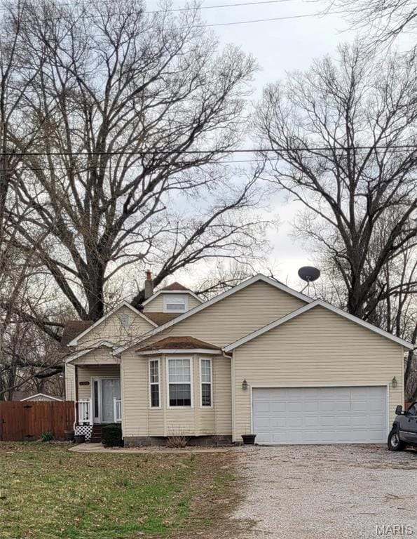 102 W High St, Troy, IL 62294 - view of front facade with gravel driveway, an attached garage, and fence