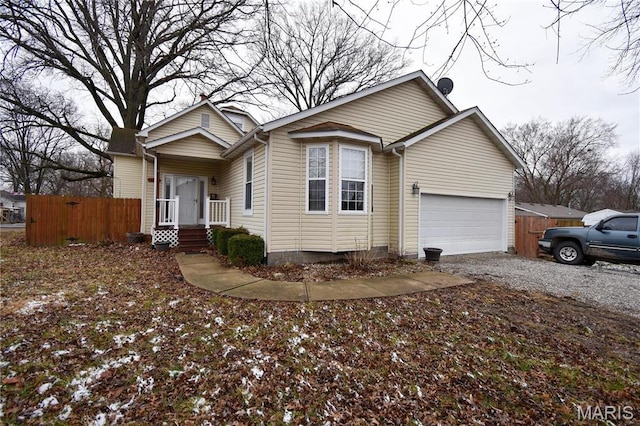 102 W High St, Troy, IL 62294 - view of front facade with fence, gravel driveway, and a garage