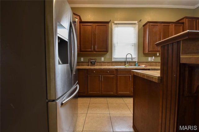 102 W High St, Troy, IL 62294 - kitchen featuring a sink, light tile patterned floors, stainless steel fridge with ice dispenser, tile counters, and crown molding