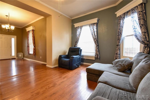 102 W High St, Troy, IL 62294 - living room with wood finished floors, ornamental molding, a chandelier, and baseboards