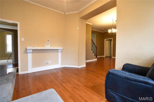102 W High St, Troy, IL 62294 - living room with crown molding, wood finished floors, stairway, a chandelier, and baseboards