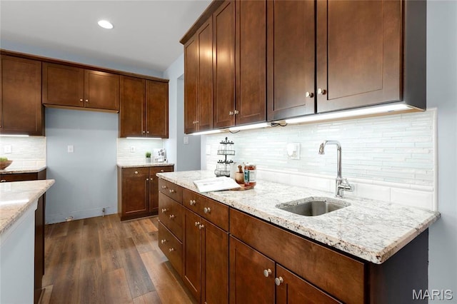 206 Willow Park Ct, Wentzville, MO 63385 - kitchen with a sink, decorative backsplash, dark wood-style floors, light stone counters, and recessed lighting