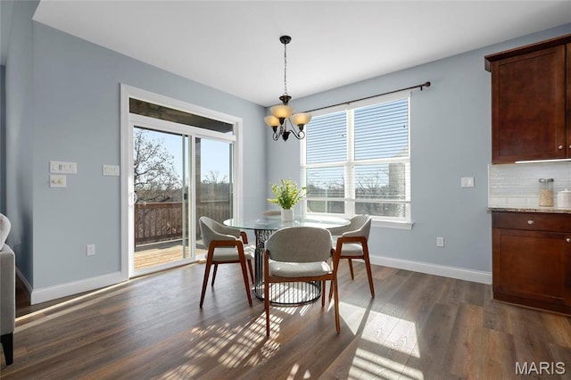 206 Willow Park Ct, Wentzville, MO 63385 - dining room featuring a chandelier, dark wood-style flooring, and baseboards