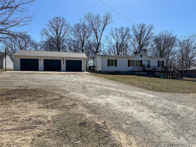 405 County Road 5015, Salem, MO 65560 - view of front of home featuring an outbuilding, a garage, dirt driveway, and a deck