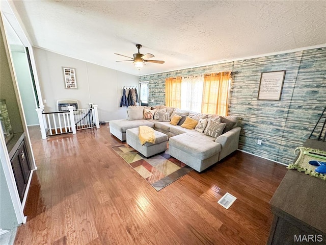 405 County Road 5015, Salem, MO 65560 - living area featuring wood finished floors, a ceiling fan, a textured ceiling, an accent wall, and vaulted ceiling
