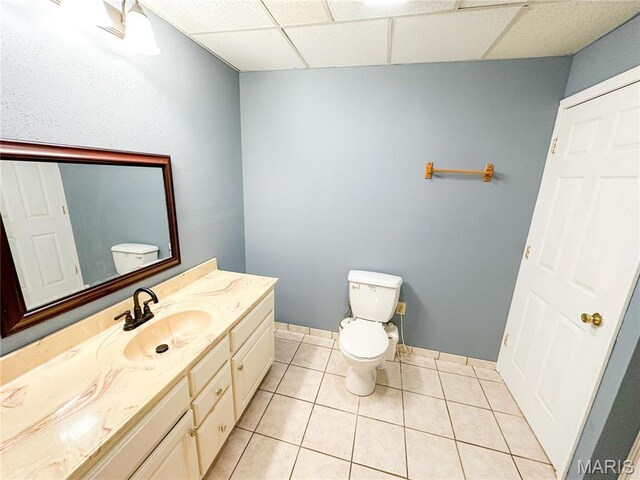 405 County Road 5015, Salem, MO 65560 - half bathroom with toilet, a paneled ceiling, vanity, and tile patterned floors