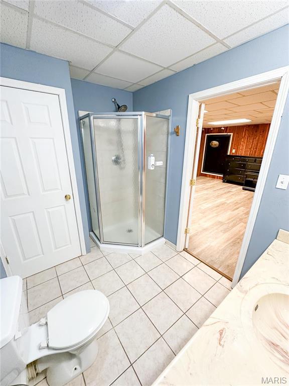 405 County Road 5015, Salem, MO 65560 - full bathroom with a stall shower, a drop ceiling, toilet, vanity, and tile patterned floors