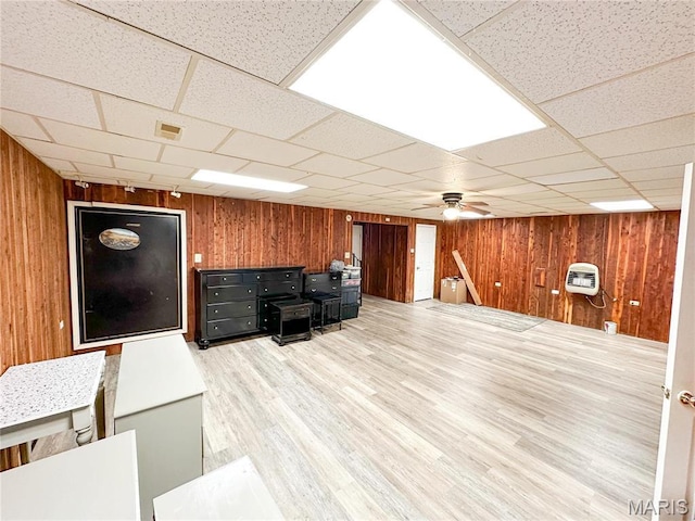 405 County Road 5015, Salem, MO 65560 - unfurnished living room with wooden walls, a drop ceiling, ceiling fan, light wood finished floors, and heating unit