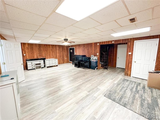 405 County Road 5015, Salem, MO 65560 - unfurnished living room with wood walls, ceiling fan, a drop ceiling, and wood finished floors