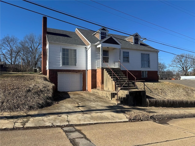 529 W Relief, Poplar Bluff, MO 63901 - view of front of property featuring a garage, concrete driveway, a chimney, and a shingled roof