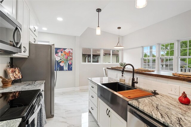 1048 Martha Ln, Saint Louis, MO 63119 - kitchen featuring stainless steel appliances, light marble finish floors, backsplash, hanging light fixtures, and white cabinets