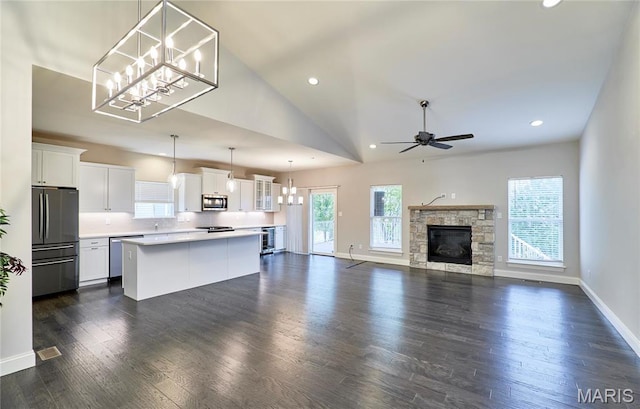 513 Upper Ridgepointe Ct, Lake St Louis, MO 63367 - unfurnished living room with a ceiling fan, a chandelier, baseboards, recessed lighting, and a stone fireplace