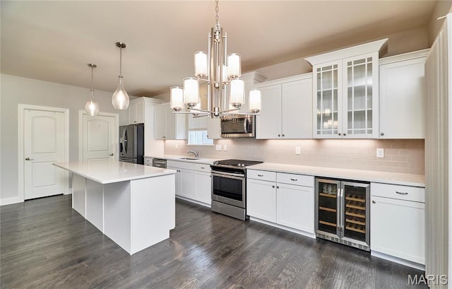 513 Upper Ridgepointe Ct, Lake St Louis, MO 63367 - kitchen with appliances with stainless steel finishes, wine cooler, white cabinetry, and decorative backsplash
