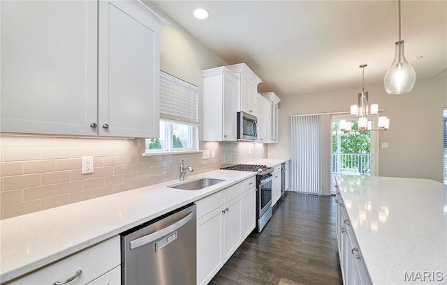 513 Upper Ridgepointe Ct, Lake St Louis, MO 63367 - kitchen with appliances with stainless steel finishes, a sink, white cabinets, tasteful backsplash, and recessed lighting