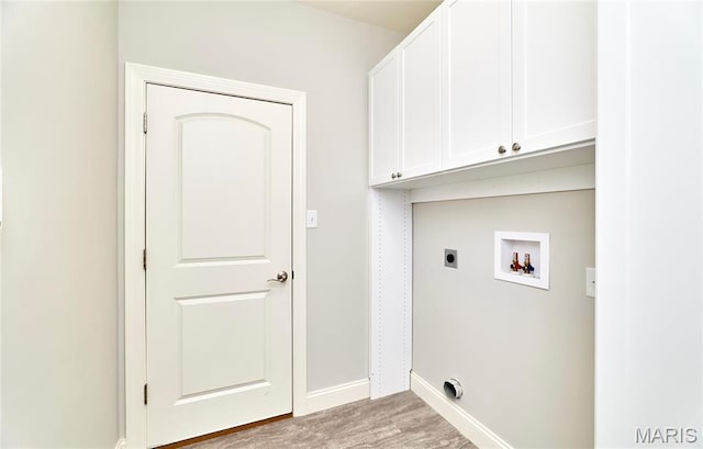 513 Upper Ridgepointe Ct, Lake St Louis, MO 63367 - laundry area featuring electric dryer hookup, cabinet space, hookup for a washing machine, wood finished floors, and baseboards