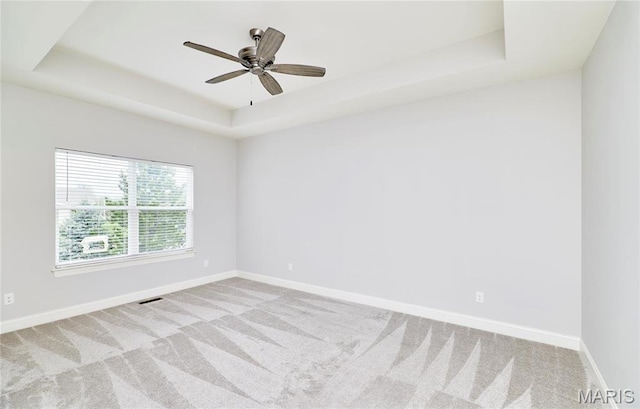 513 Upper Ridgepointe Ct, Lake St Louis, MO 63367 - carpeted empty room featuring a tray ceiling, baseboards, and ceiling fan