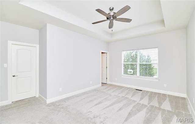 513 Upper Ridgepointe Ct, Lake St Louis, MO 63367 - unfurnished room featuring a tray ceiling, carpet flooring, a ceiling fan, and baseboards