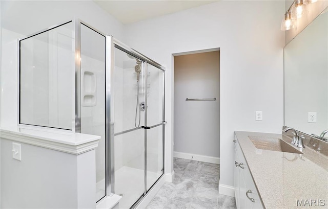 513 Upper Ridgepointe Ct, Lake St Louis, MO 63367 - full bathroom with marble look tiles, a shower stall, baseboards, and vanity