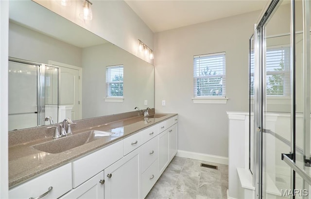 513 Upper Ridgepointe Ct, Lake St Louis, MO 63367 - bathroom featuring healthy amount of natural light, baseboards, and double vanity