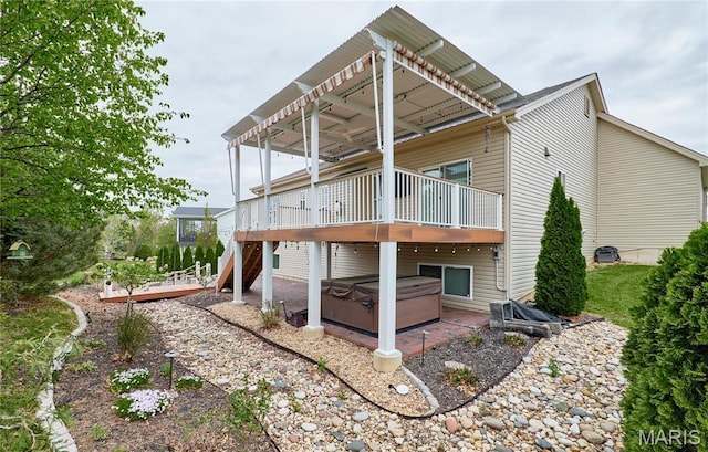 513 Upper Ridgepointe Ct, Lake St Louis, MO 63367 - back of property with a hot tub, a wooden deck, and a patio area