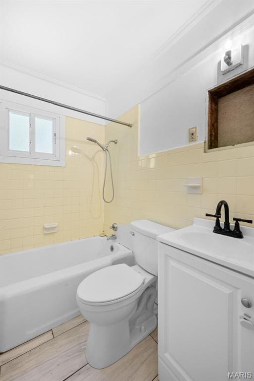6541 SW Ave, Saint Louis, MO 63139 - bathroom featuring tile walls, vanity, shower / washtub combination, and wood finished floors