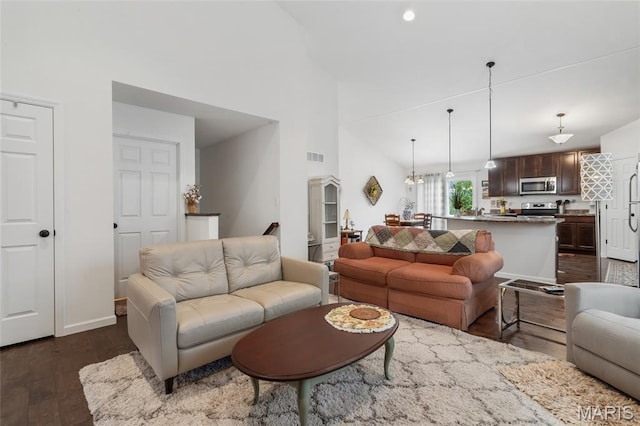 5374 Trailhead Ct, Eureka, MO 63025 - living area featuring dark wood-style floors, a towering ceiling, and baseboards