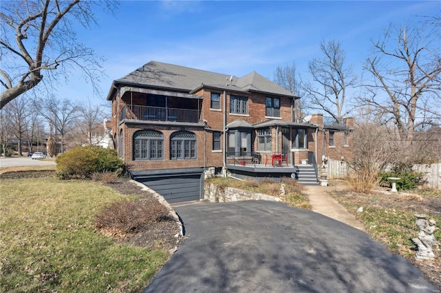 364 Mission Ct, Saint Louis, MO 63130 - view of front of property featuring a balcony, a garage, brick siding, and asphalt driveway