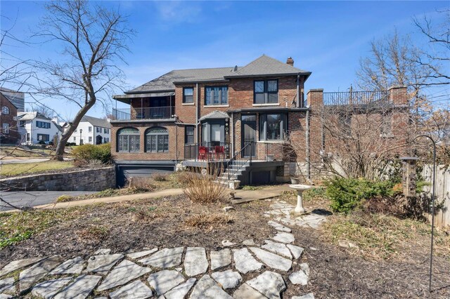 364 Mission Ct, Saint Louis, MO 63130 - view of front of property featuring brick siding, a balcony, and a chimney