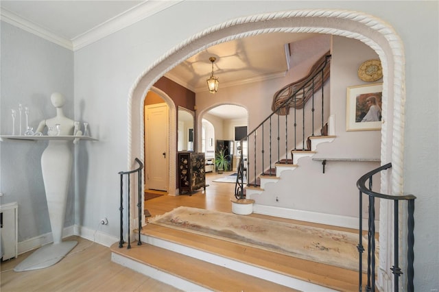 364 Mission Ct, Saint Louis, MO 63130 - foyer entrance with arched walkways, wood finished floors, baseboards, ornamental molding, and stairs
