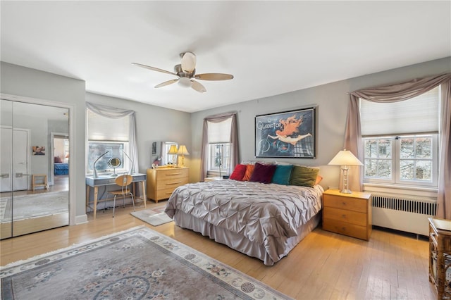 364 Mission Ct, Saint Louis, MO 63130 - bedroom featuring radiator, multiple windows, and hardwood / wood-style flooring