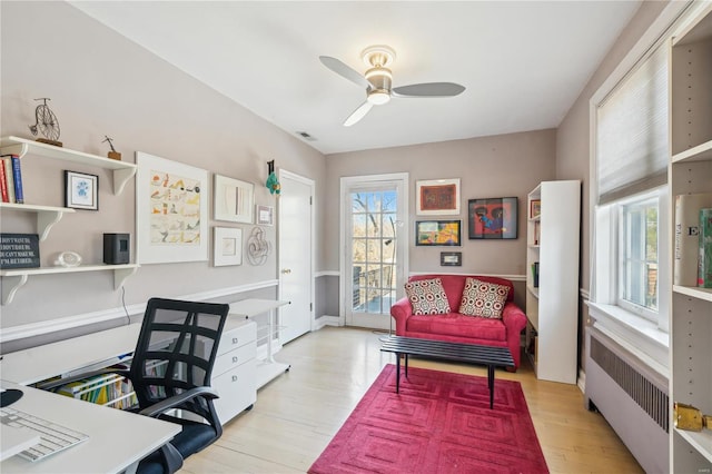 364 Mission Ct, Saint Louis, MO 63130 - office area with radiator, ceiling fan, and wood finished floors