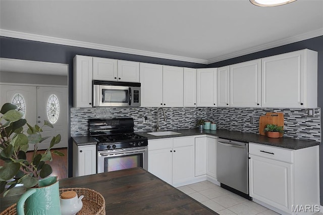 438 Rockview Dr, Saint Louis, MO 63129 - kitchen with stainless steel appliances, dark countertops, white cabinets, decorative backsplash, and ornamental molding