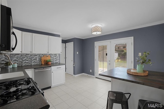 438 Rockview Dr, Saint Louis, MO 63129 - kitchen featuring stainless steel dishwasher, french doors, tasteful backsplash, white cabinets, and gas range