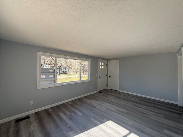 6043 Parkedge Dr, House Springs, MO 63051 - foyer entrance featuring a textured ceiling, wood finished floors, and baseboards