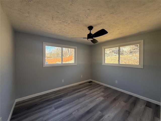 6043 Parkedge Dr, House Springs, MO 63051 - unfurnished room with a textured ceiling, dark wood-type flooring, ceiling fan, and baseboards