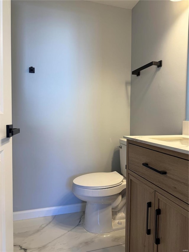 6043 Parkedge Dr, House Springs, MO 63051 - bathroom with marble look tiles, vanity, toilet, and baseboards