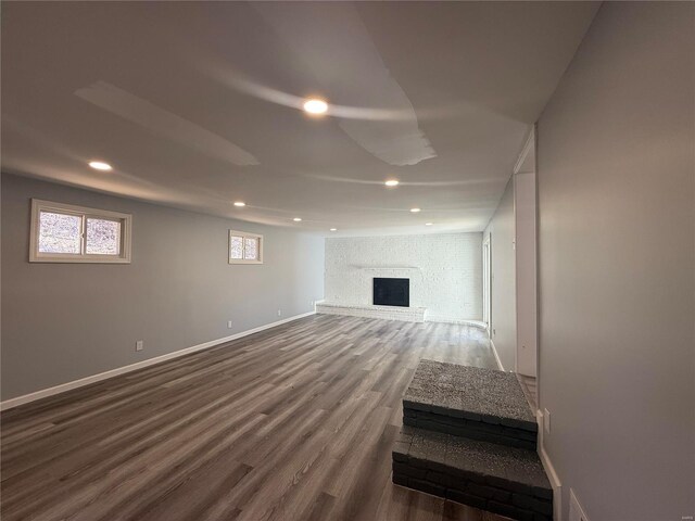 6043 Parkedge Dr, House Springs, MO 63051 - basement featuring wood finished floors, a brick fireplace, recessed lighting, and baseboards