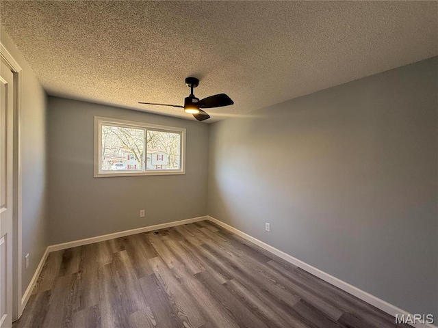 6043 Parkedge Dr, House Springs, MO 63051 - empty room featuring a ceiling fan, dark wood-style floors, and a textured ceiling