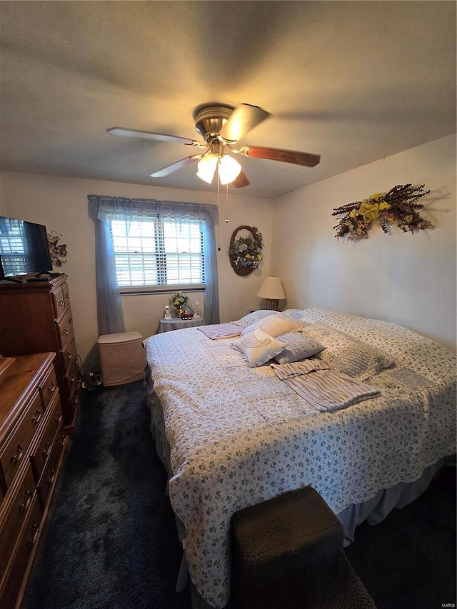 bedroom featuring dark colored carpet and ceiling fan