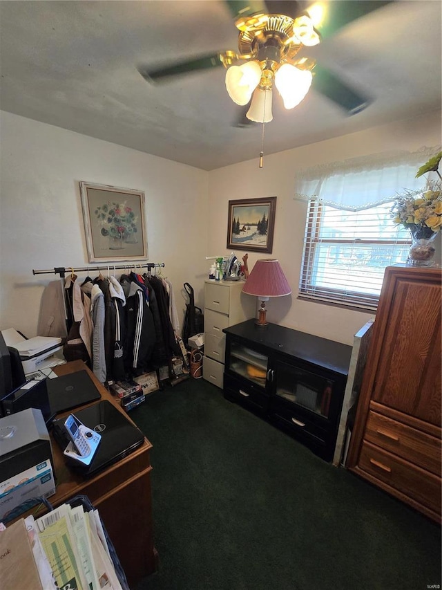 walk in closet with ceiling fan and carpet