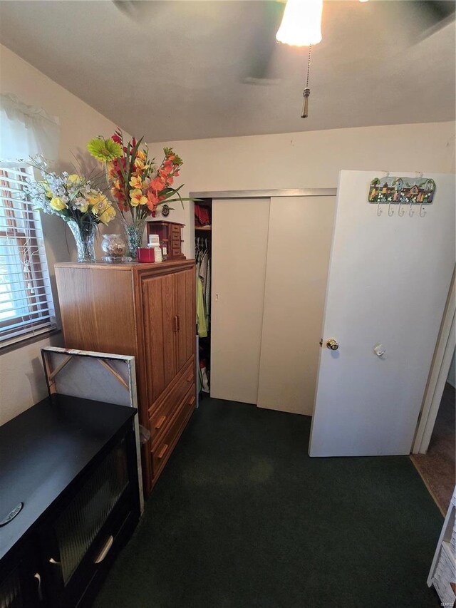 hallway featuring dark colored carpet