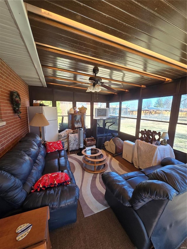 carpeted living area with brick wall, ceiling fan, and cooling unit
