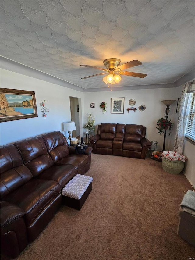 carpeted living area featuring ceiling fan