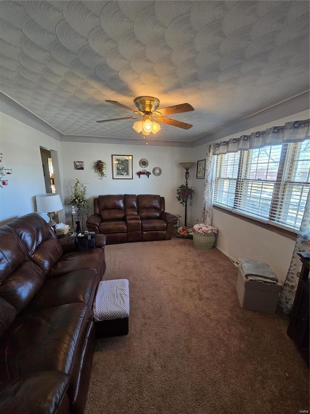 carpeted living area featuring ceiling fan